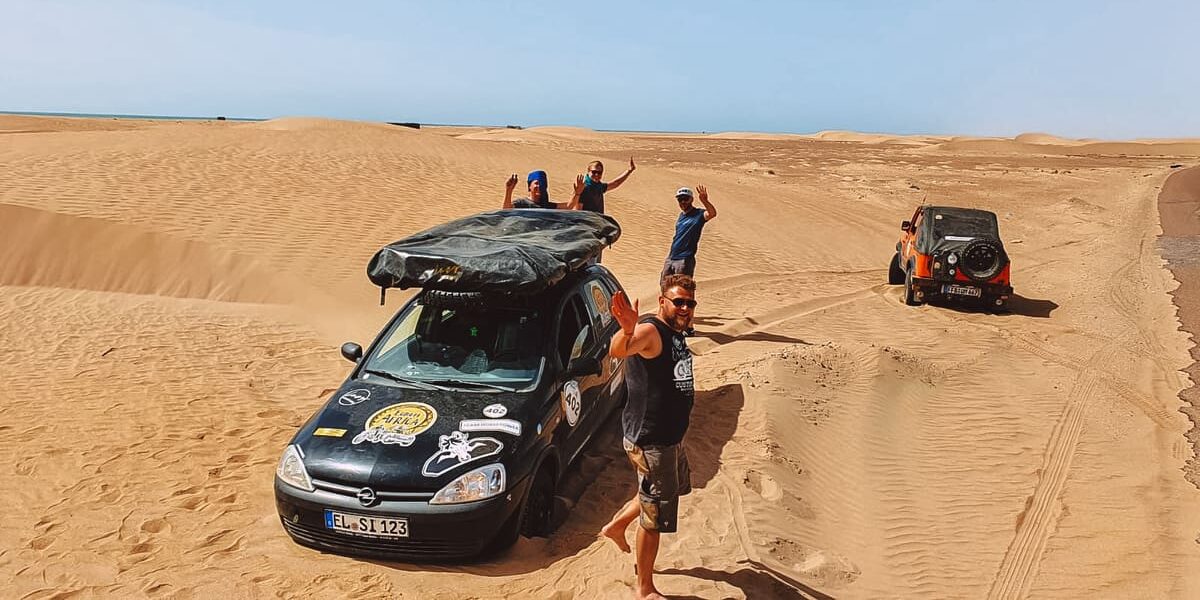 Opel Corsa mit Dachzelt in der Wüste in Marokko in LAYZEE Stories