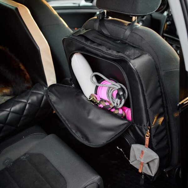 Black bag on car seat packed with utensils from layzee camping.